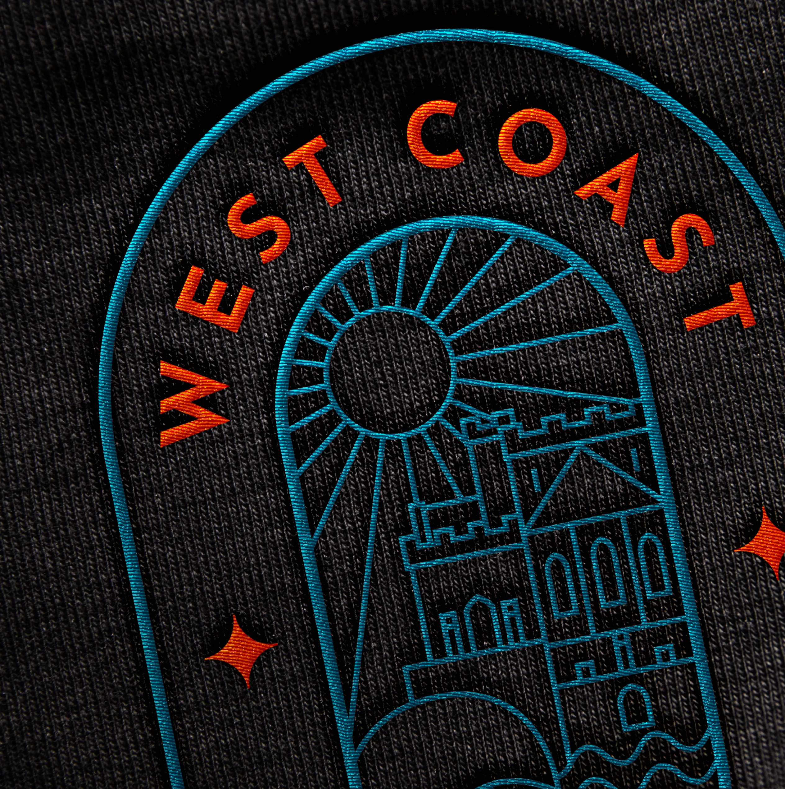 West Coast Fitness logo embroidered on dark branded workwear, designed by DotPerformance for the Peel community fitness centre on the Isle of Man